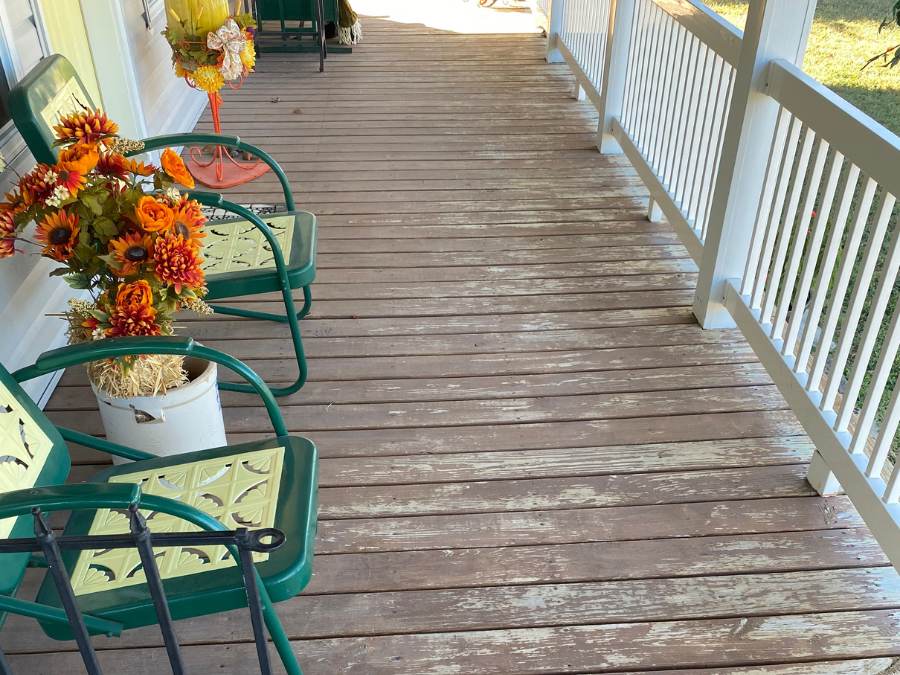 Before picture of porch deck that had been painted with paint chips coming off.